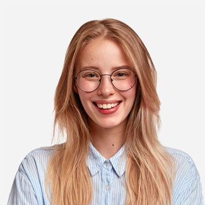 Smiling young woman with glasses, illustrating an implant-supported bridge patient